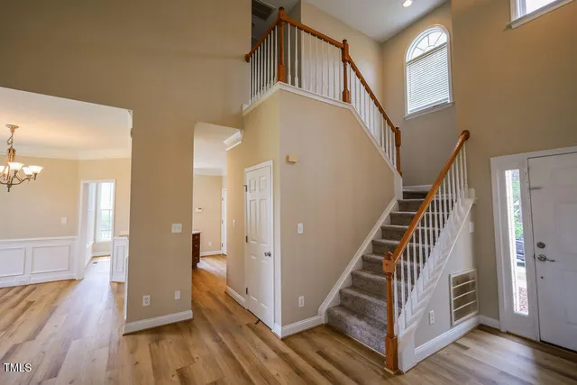 a view of entryway and hall with wooden floor
