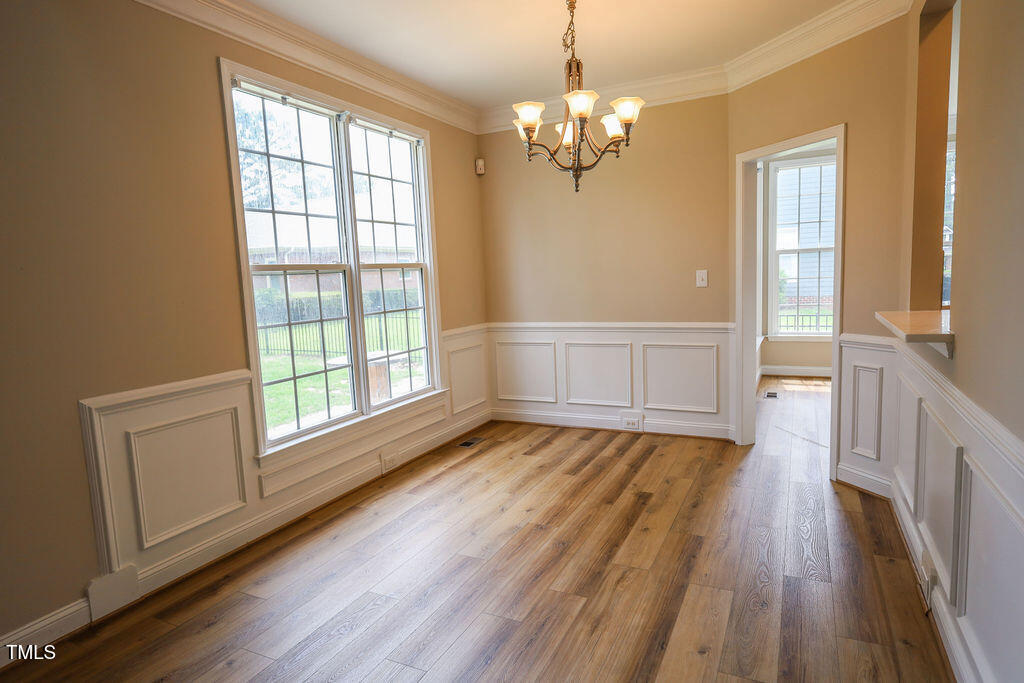 10 London Way Spring Lake, NC 28390 - Photo 9 of 26 a view of an empty room with wooden floor and a window