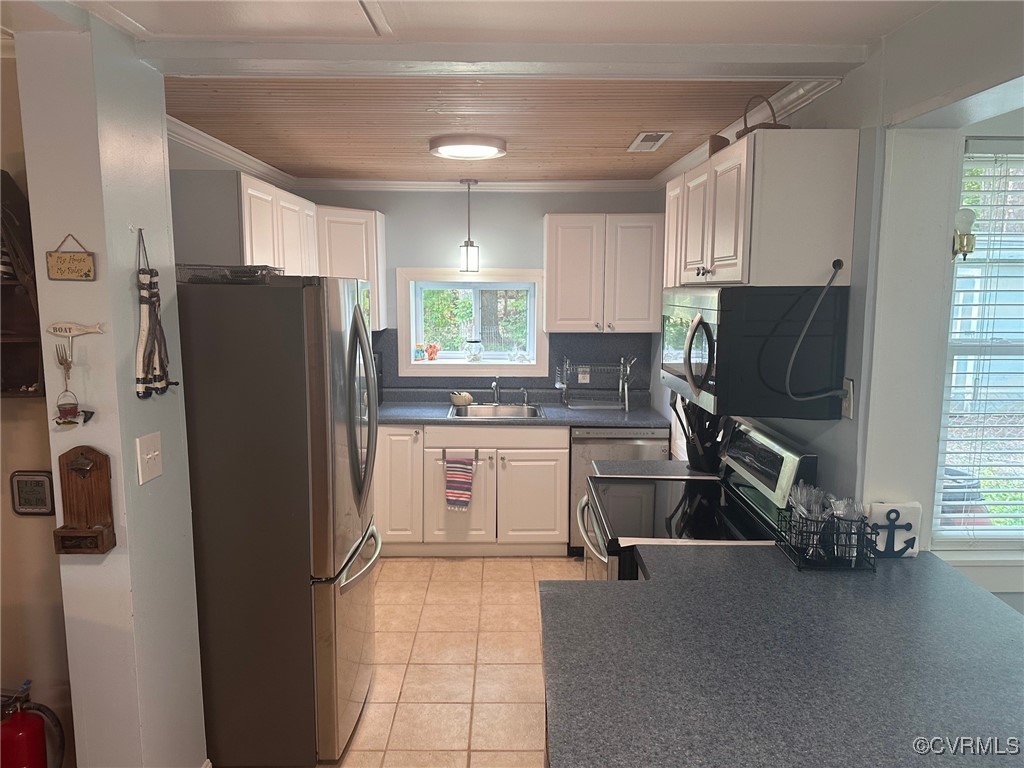328 Cow Shed Road Lancaster, VA 22503 - Photo 13 of 27 a kitchen with a refrigerator a stove a sink dishwasher and cabinets with wooden floor