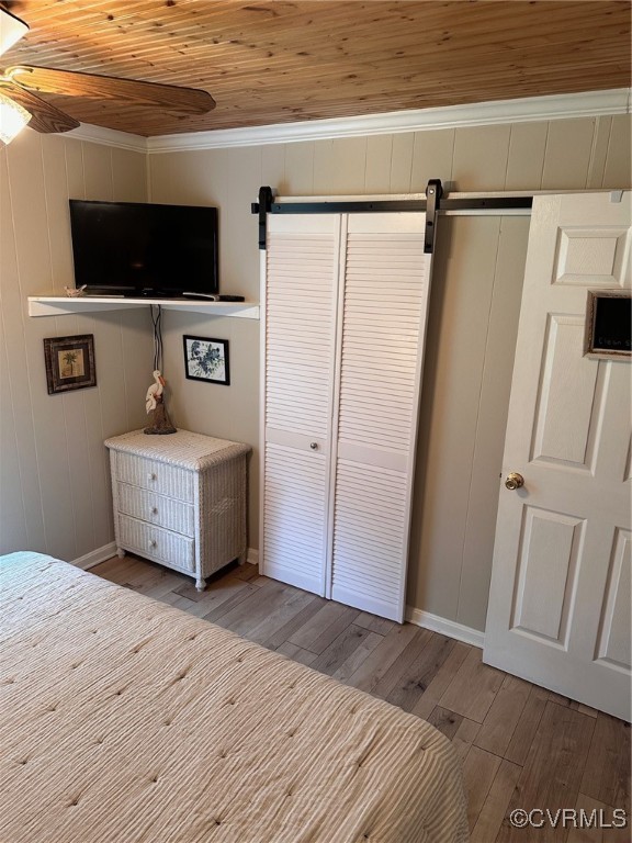 328 Cow Shed Road Lancaster, VA 22503 - Photo 17 of 27 a bedroom with a bed and a flat screen tv