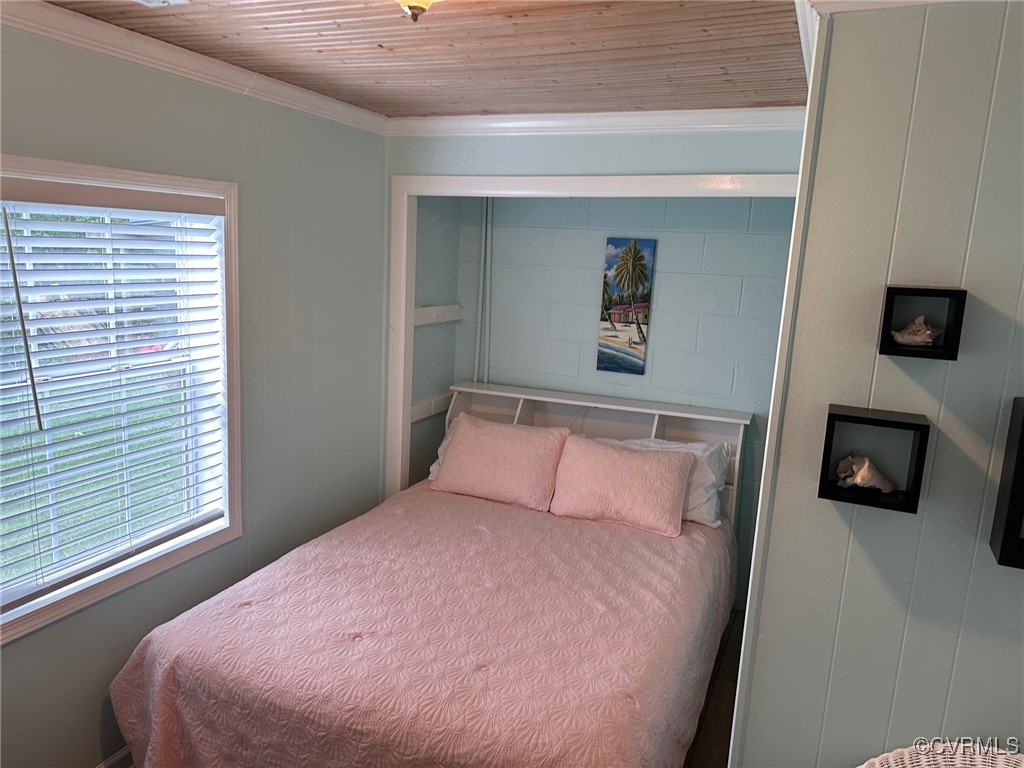 328 Cow Shed Road Lancaster, VA 22503 - Photo 21 of 27 a bedroom with a bed and a television
