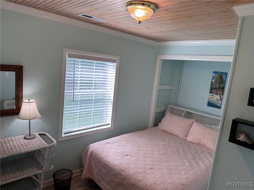 328 Cow Shed Road Lancaster, VA 22503 - Photo 22 of 27 a bedroom with a bed and a lamp