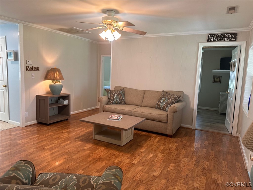 328 Cow Shed Road Lancaster, VA 22503 - Photo 9 of 27 a living room with furniture and a chandelier