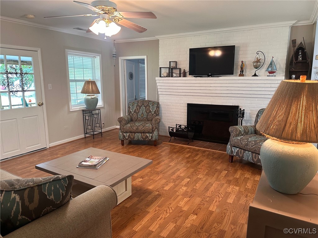328 Cow Shed Road Lancaster, VA 22503 - Photo 10 of 27 a living room with furniture a flat screen tv and a fireplace