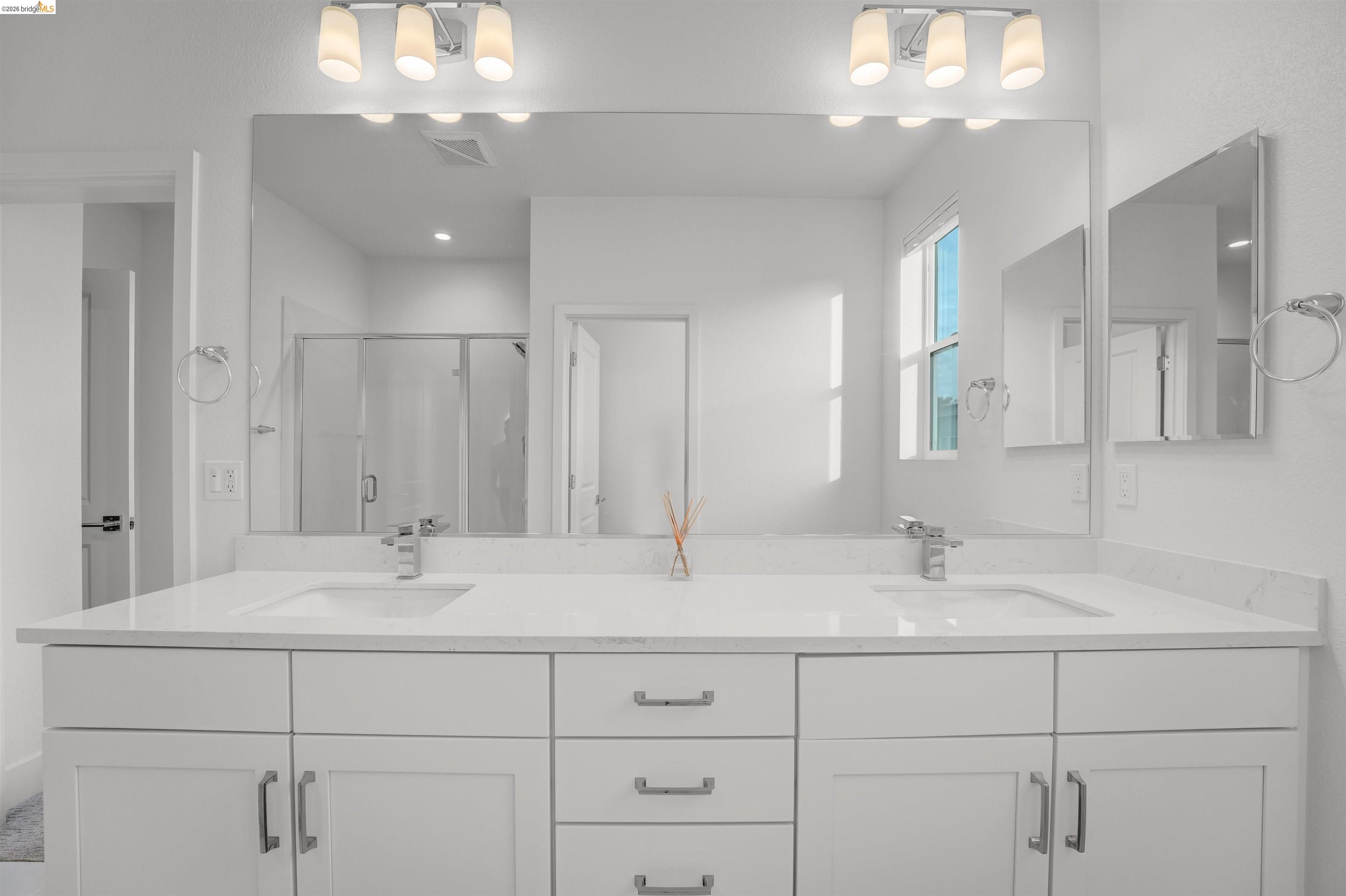 7101 Melon Court San Ramon, CA 94583 - Photo 50 of 58 a bathroom with double vanity sinks a vanity a lamp and a mirror
