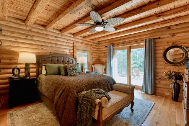 a view of a room with a closet and wooden floor