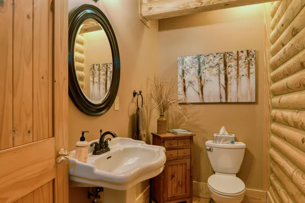 a view of a porch with a table and chairs under an umbrella