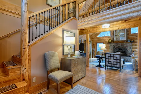 an aerial view of a houses with outdoor space and trees all around