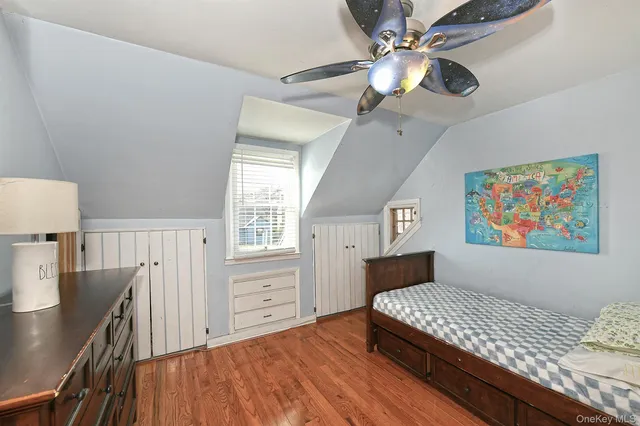 a bedroom with furniture and wooden floor