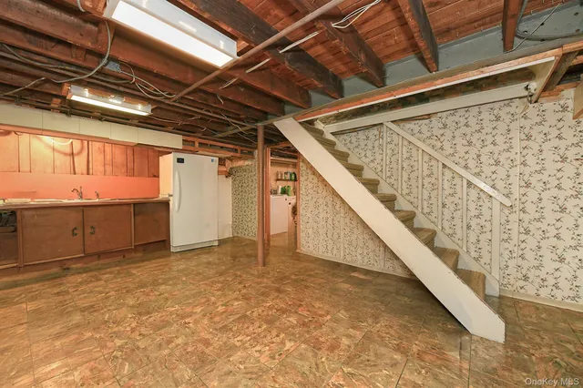a view of house with outdoor seating and covered with trees