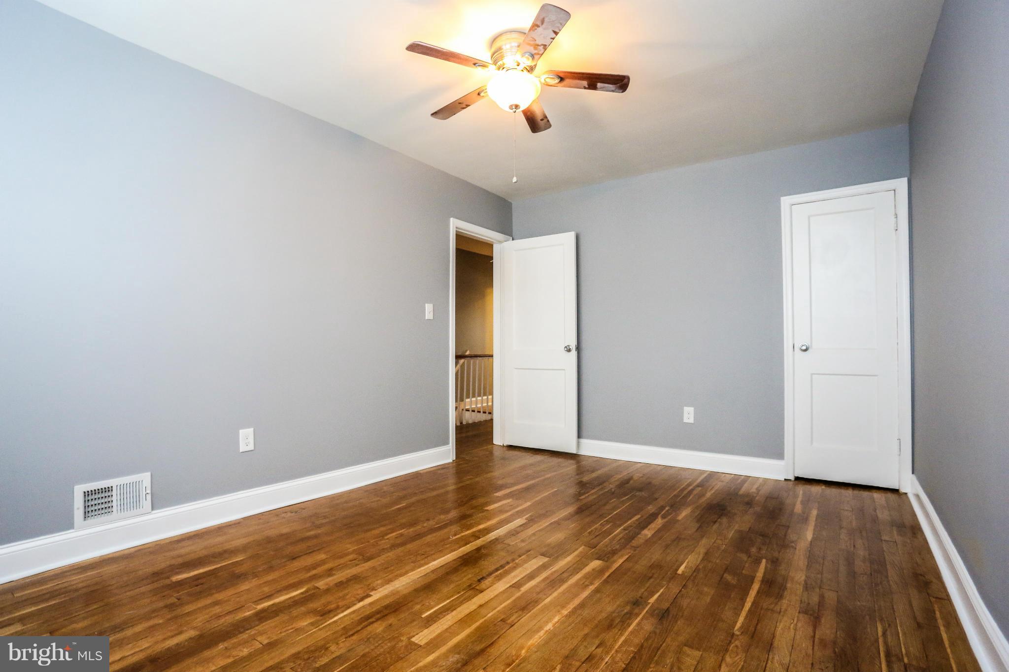 8163 Kavanagh Road Dundalk, MD 21222 - Photo 14 of 21 a view of an empty room and wooden floor
