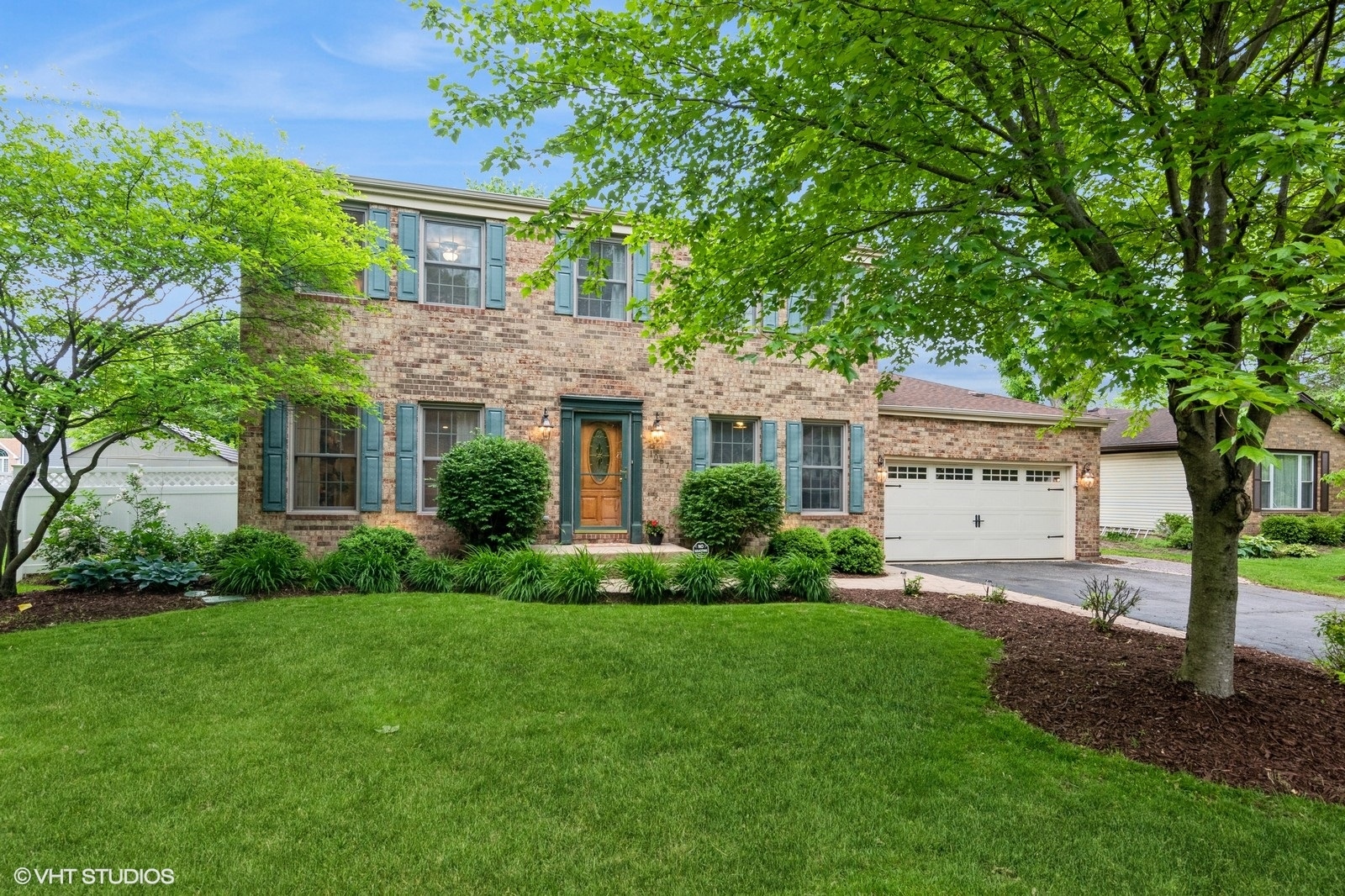 1057 Ponca Drive Batavia, IL 60510 - Photo 1 of 23 a front view of a house with a yard and trees