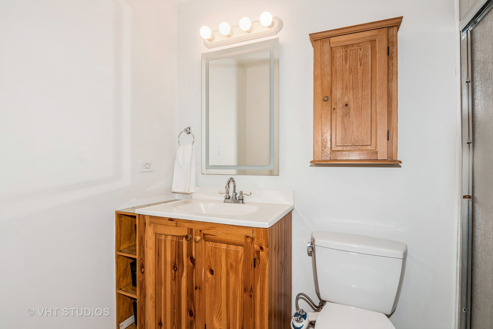 1057 Ponca Drive Batavia, IL 60510 - Photo 12 of 23 a bathroom with a sink a toilet and mirror