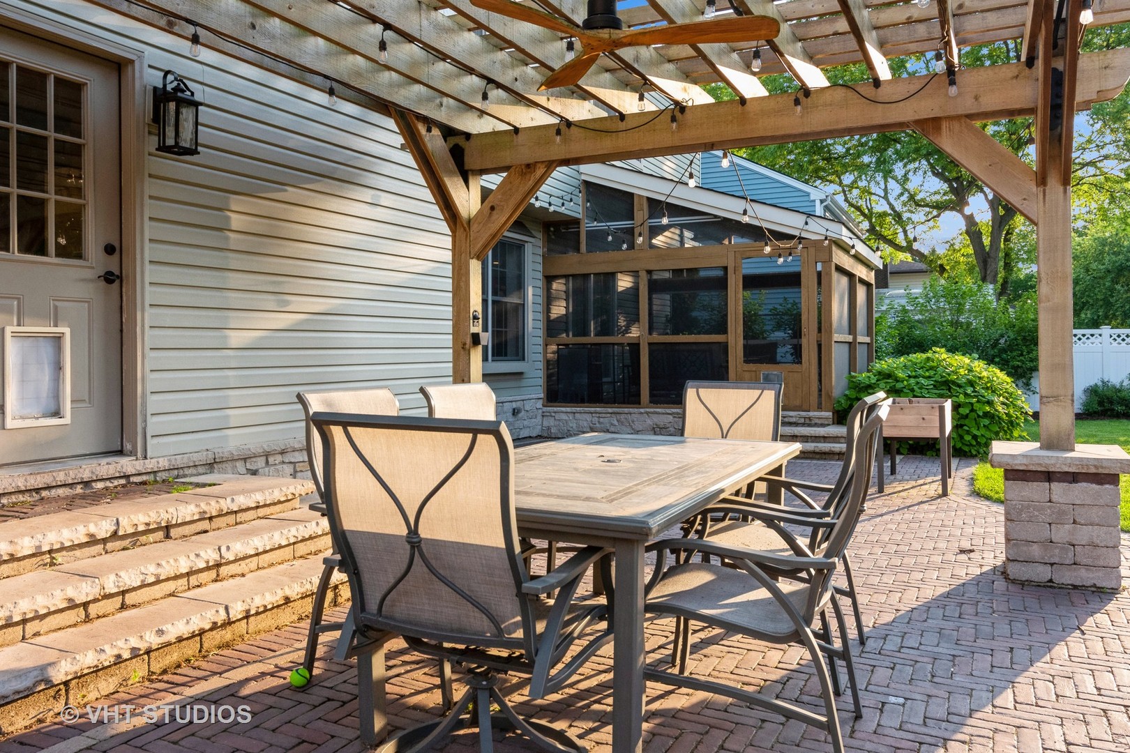 1057 Ponca Drive Batavia, IL 60510 - Photo 23 of 23 a view of a patio with a table and chairs and couches with wooden floor and fence