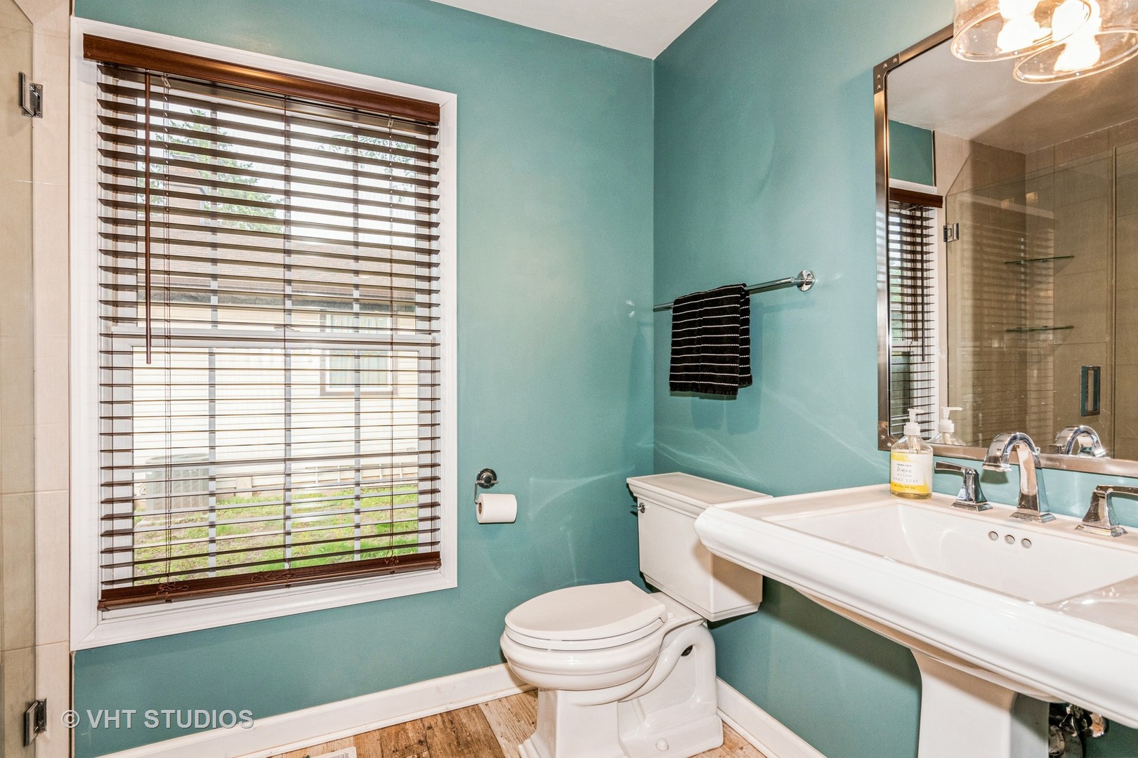1057 Ponca Drive Batavia, IL 60510 - Photo 10 of 23 a bathroom with a granite countertop toilet a sink a mirror and a window