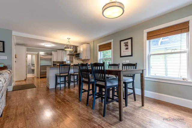 a view of a dining room with furniture and wooden floor