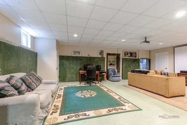 a living room with furniture flat screen tv and pool table