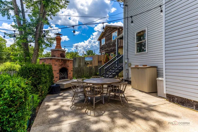 a view of a patio with table and chairs and potted plants