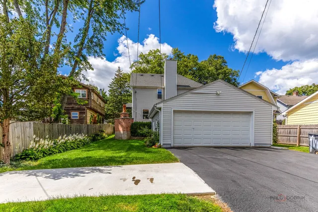a front view of a house with a yard and a garage