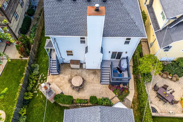 an aerial view of a house with swimming pool and patio