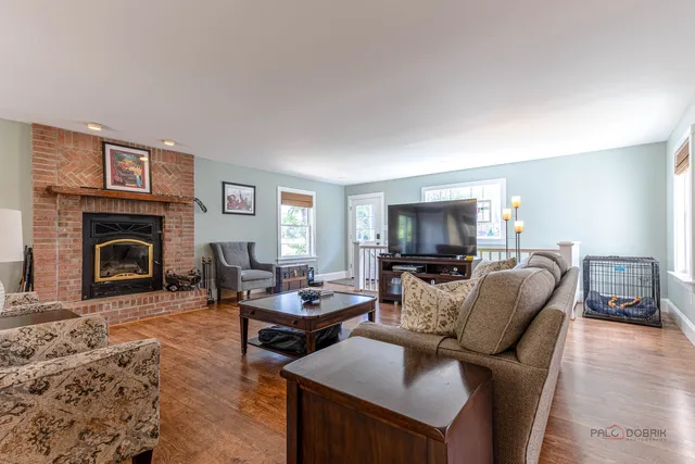 a living room with furniture a fireplace and a flat screen tv