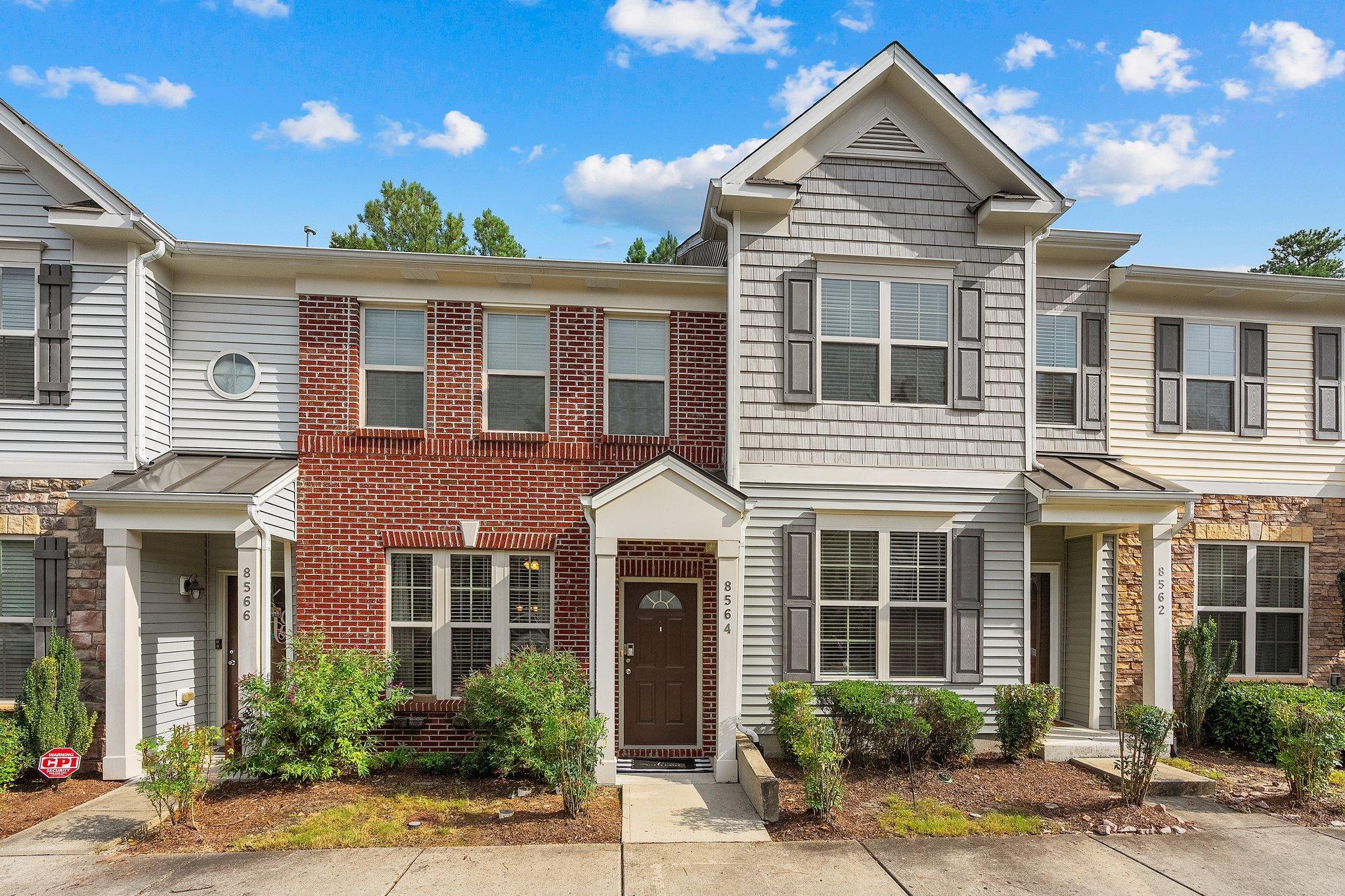 8564 Quarton Drive Raleigh, NC 27616 - Photo 1 of 28 front view of a brick house with a small yard