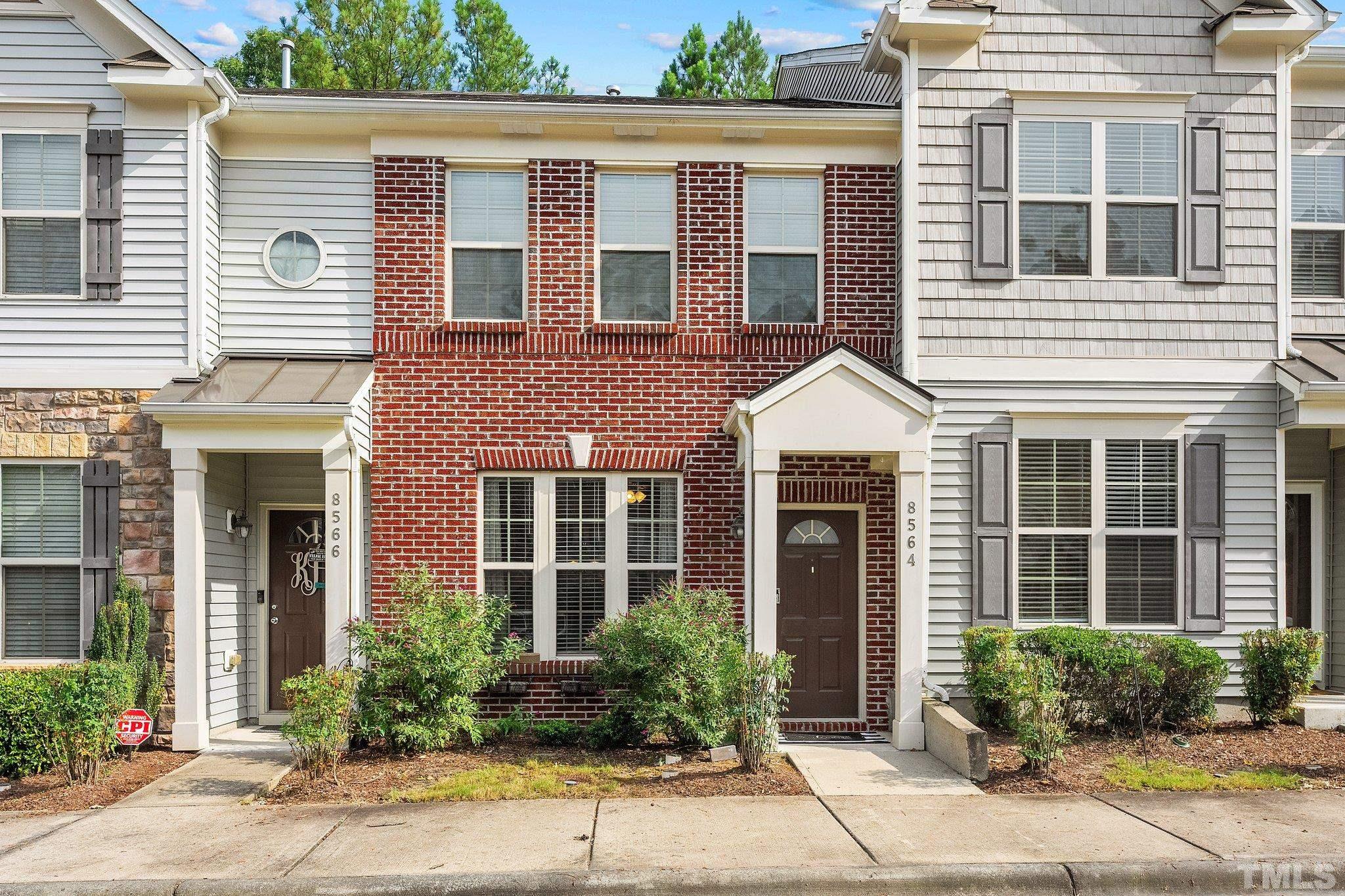 8564 Quarton Drive Raleigh, NC 27616 - Photo 2 of 28 a view of a brick house with potted plants