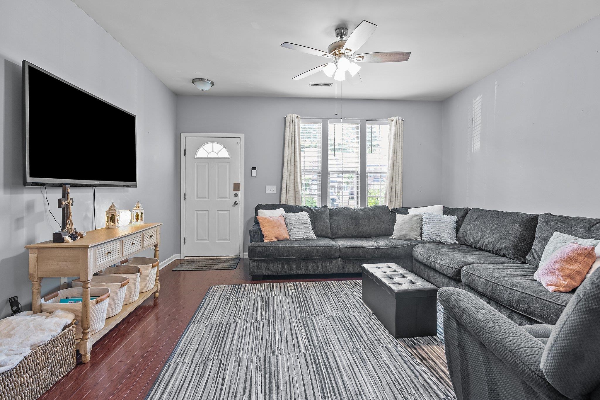 8564 Quarton Drive Raleigh, NC 27616 - Photo 4 of 28 a living room with furniture and a flat screen tv