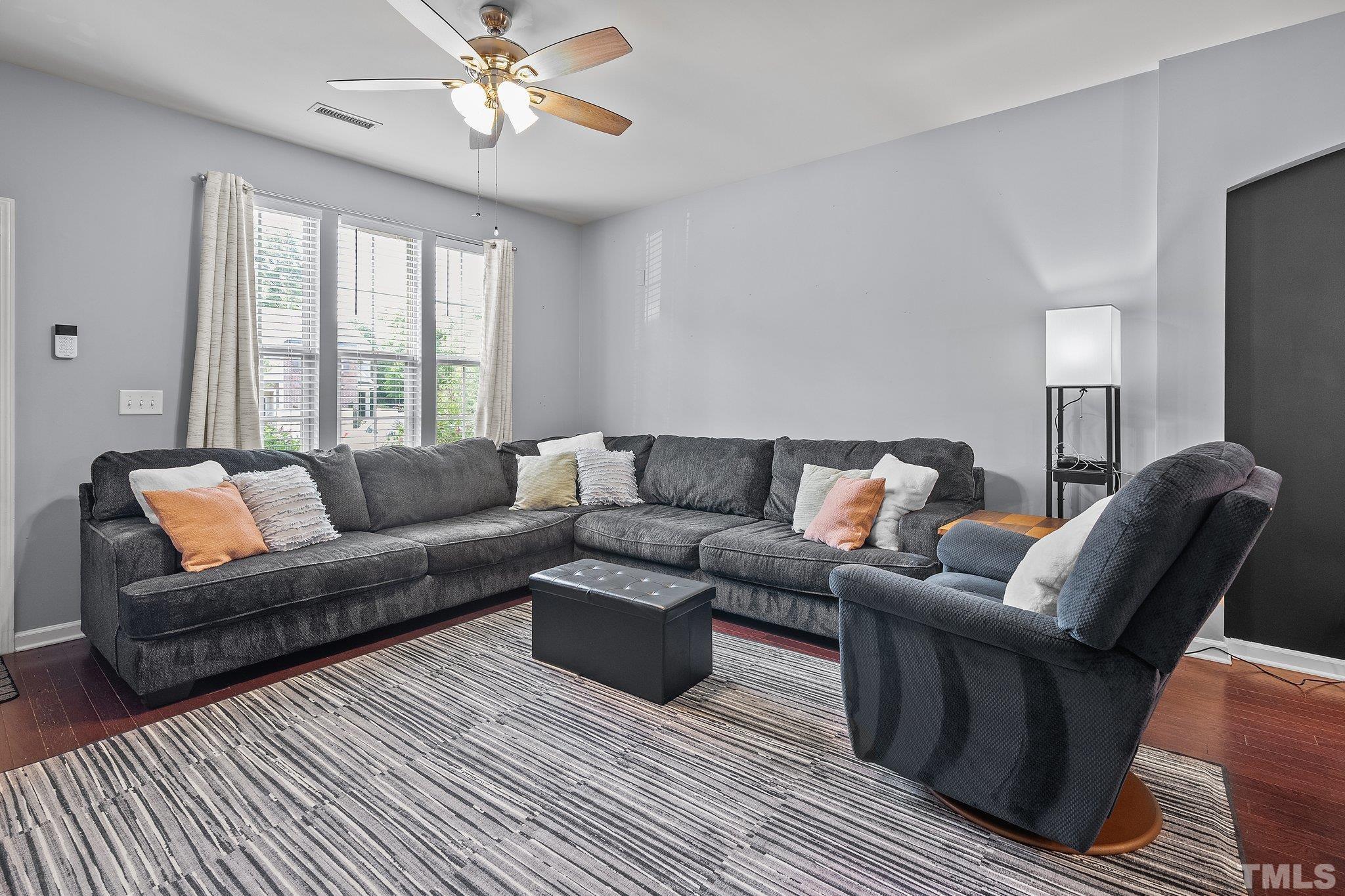 8564 Quarton Drive Raleigh, NC 27616 - Photo 5 of 28 a living room with furniture a large window and a chandelier