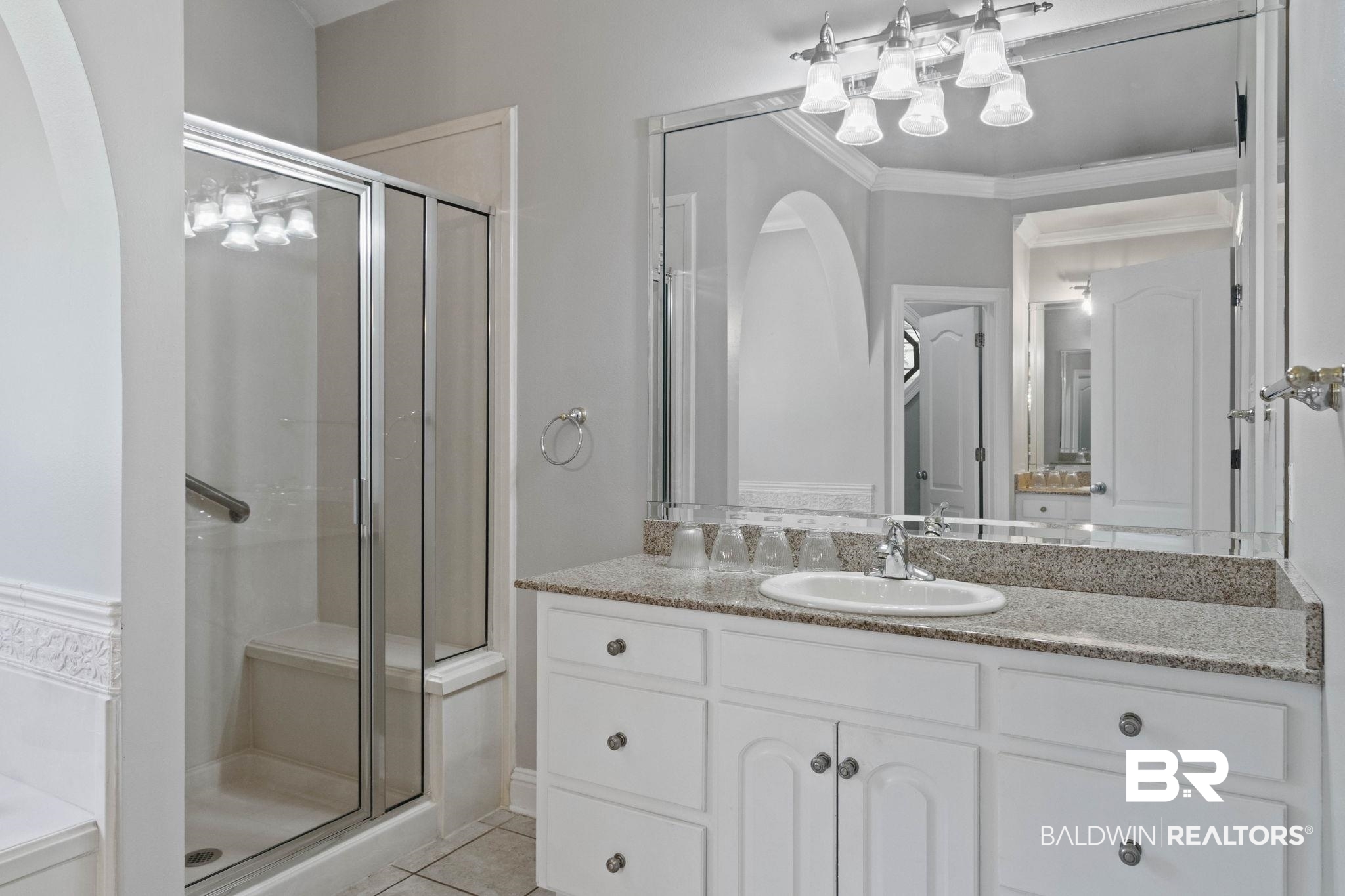 3176 Cedar Court Mobile, AL 36619 - Photo 17 of 33 Bathroom featuring a white vanity with an undermount sink, a speckled countertop, and an expansive mirror