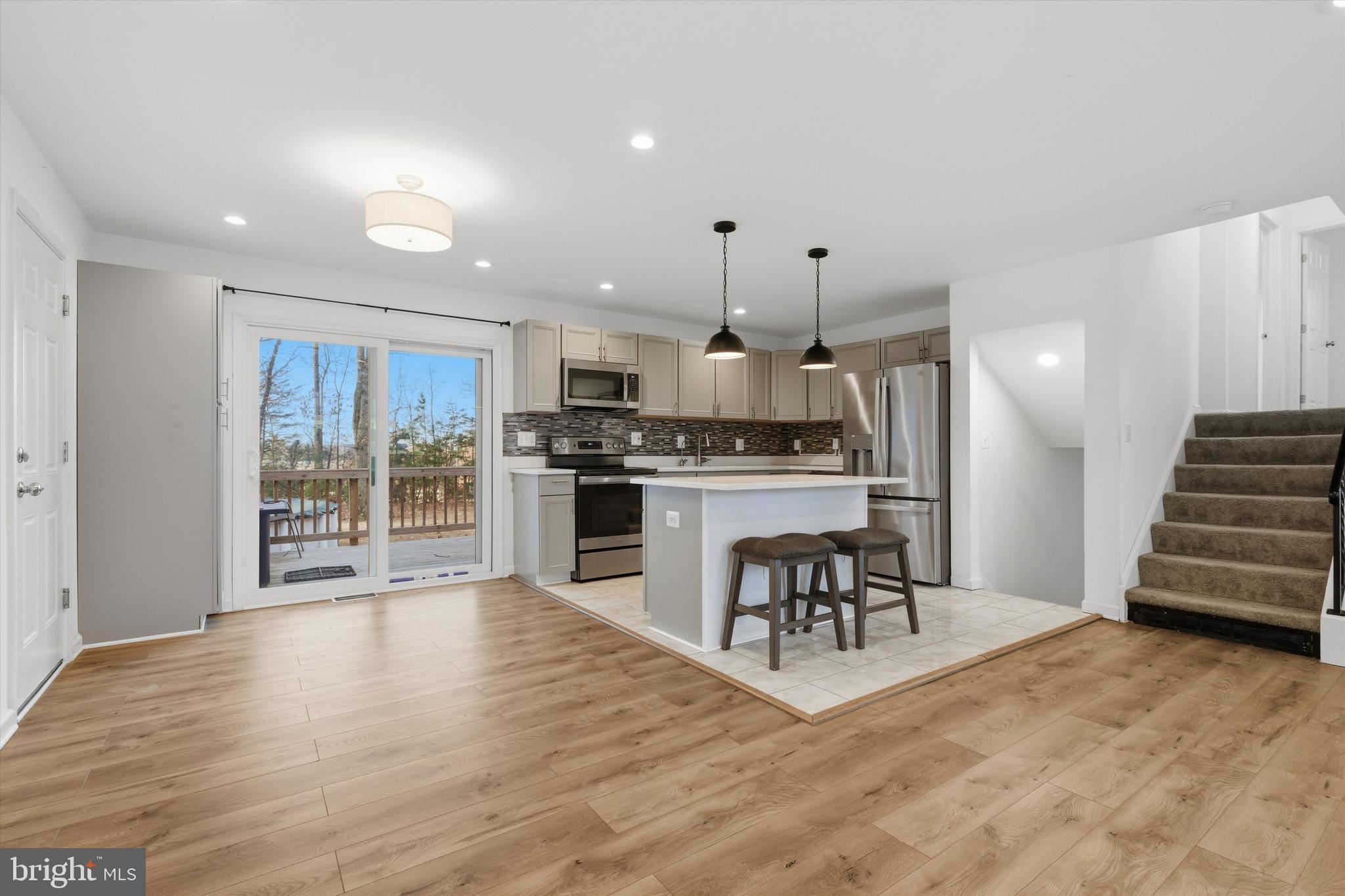 7428 Hawkins Drive Hanover, MD 21076 - Photo 11 of 44 a kitchen with a table chairs refrigerator and cabinets