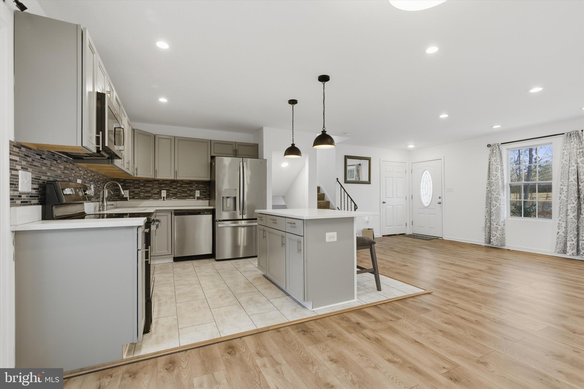 7428 Hawkins Drive Hanover, MD 21076 - Photo 13 of 44 a kitchen with a sink stainless steel appliances and cabinets