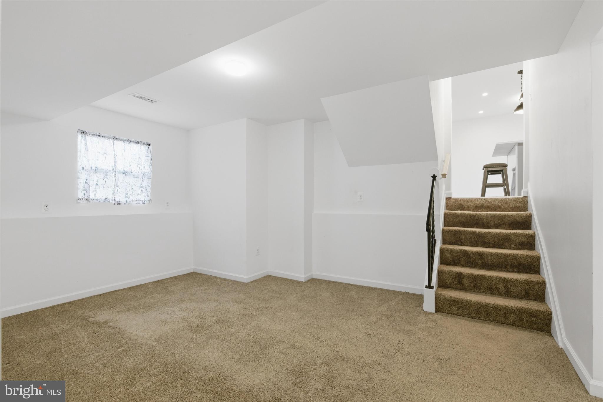 7428 Hawkins Drive Hanover, MD 21076 - Photo 16 of 44 a view of room with stairs and a window