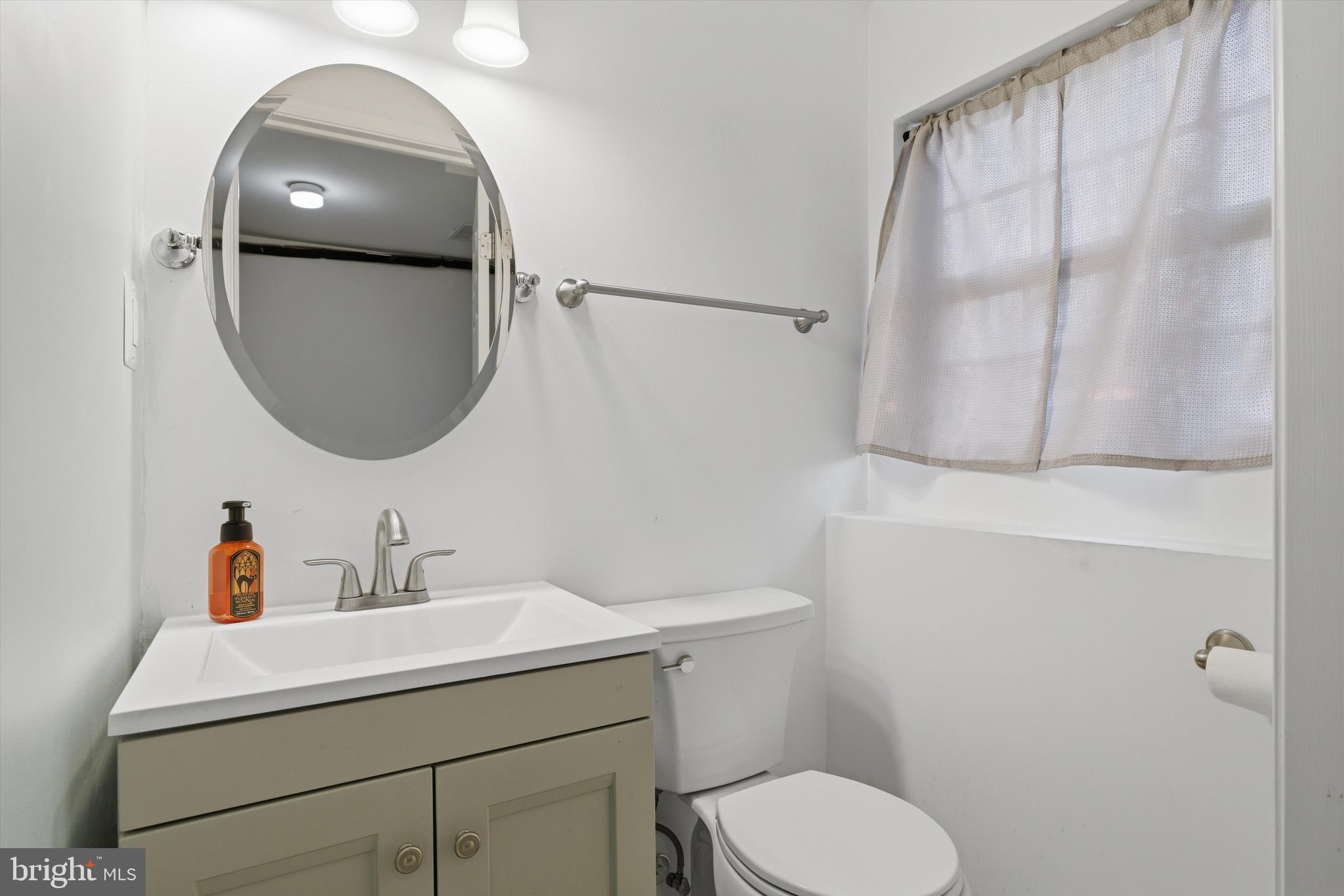 7428 Hawkins Drive Hanover, MD 21076 - Photo 25 of 44 a bathroom with a sink toilet and mirror