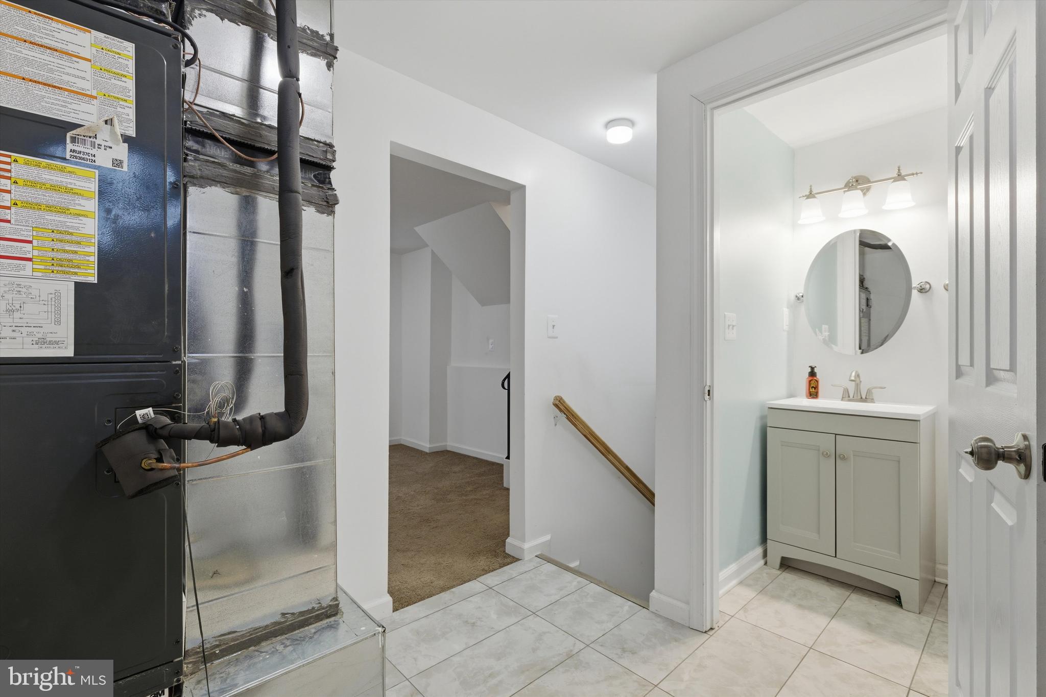 7428 Hawkins Drive Hanover, MD 21076 - Photo 26 of 44 a bathroom with a sink and mirror