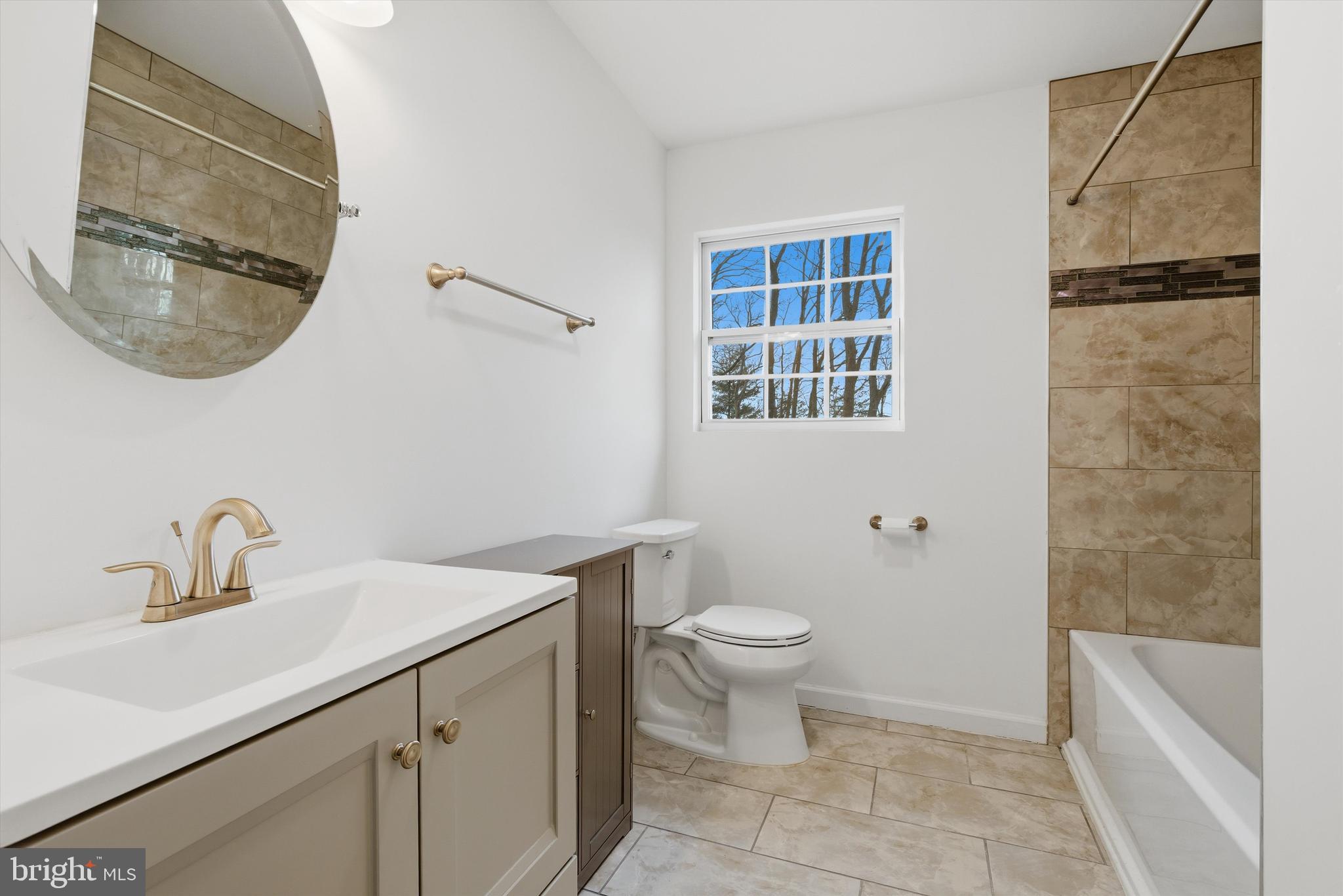 7428 Hawkins Drive Hanover, MD 21076 - Photo 29 of 44 a bathroom with a sink and a mirror