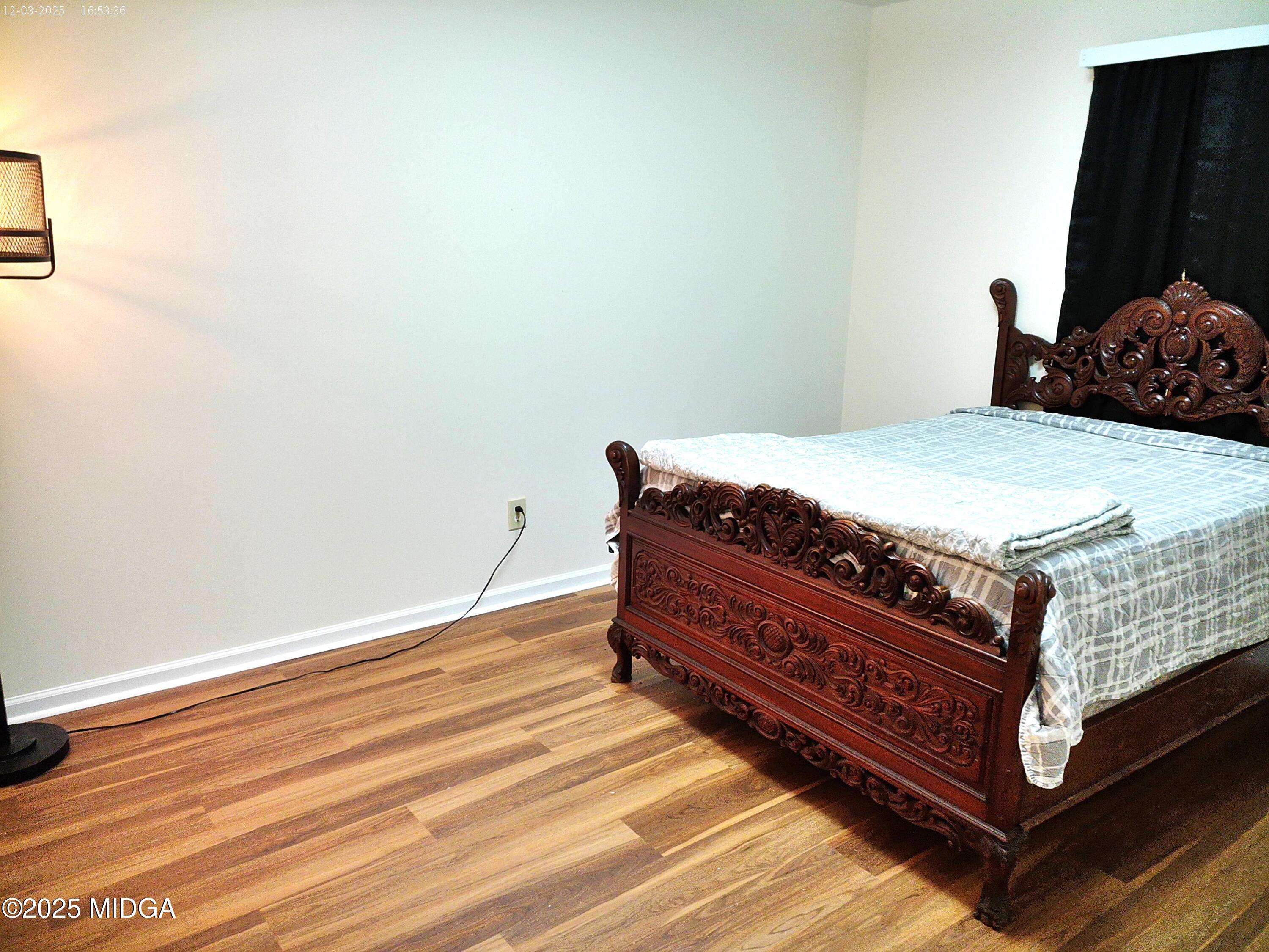 3850 Hitchcock Road Macon, GA 31217 - Photo 4 of 14 a bed sitting in a bedroom next to a window