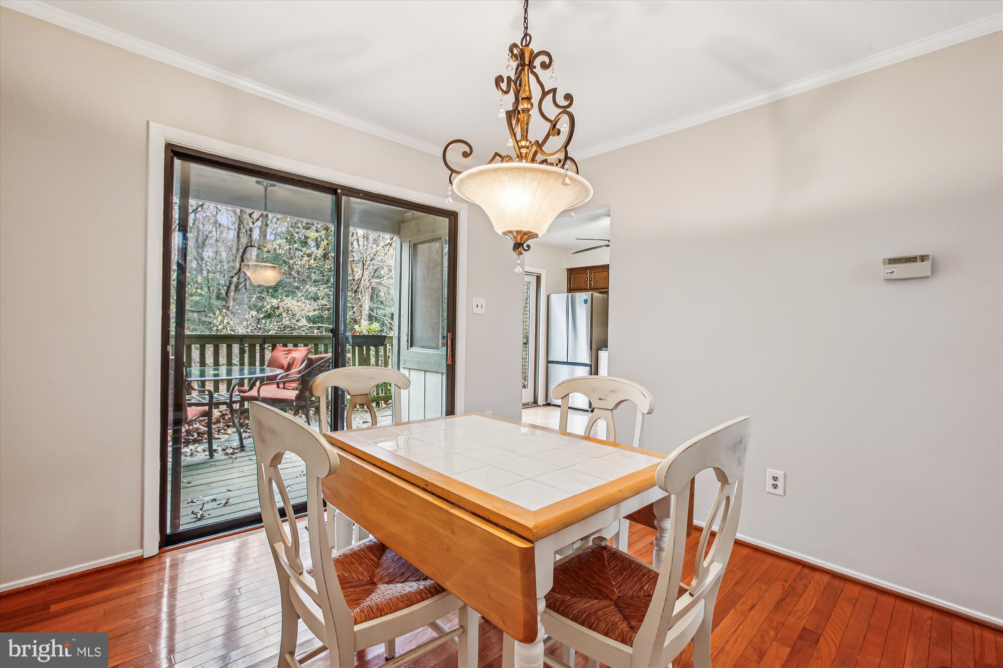 2025 Winged Foot Court Reston, VA 20191 - Photo 11 of 59 a dining room with furniture a chandelier and wooden floor