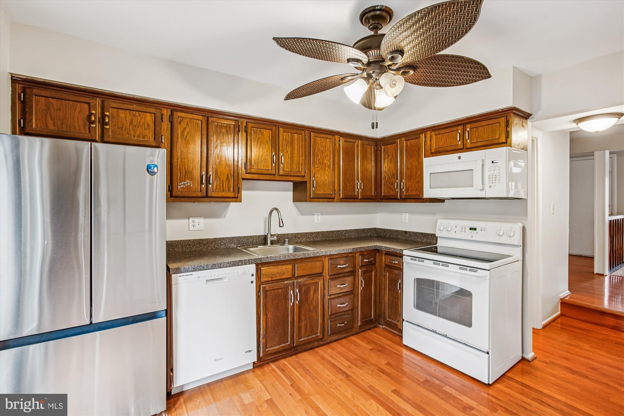 2025 Winged Foot Court Reston, VA 20191 - Photo 15 of 59 a kitchen with stainless steel appliances granite countertop a stove cabinets and a refrigerator