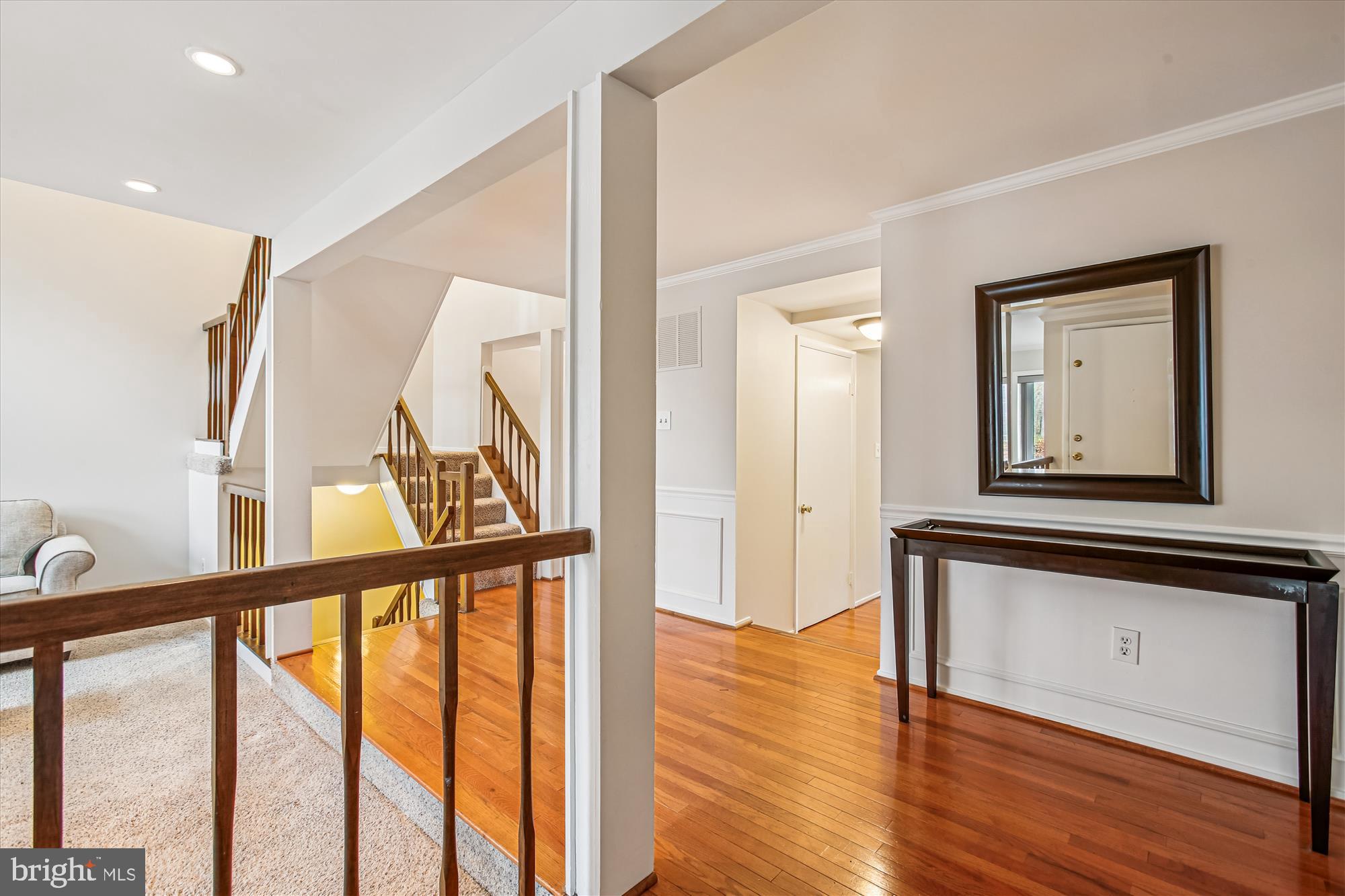 2025 Winged Foot Court Reston, VA 20191 - Photo 8 of 59 a view of front door with wooden floor and stairs