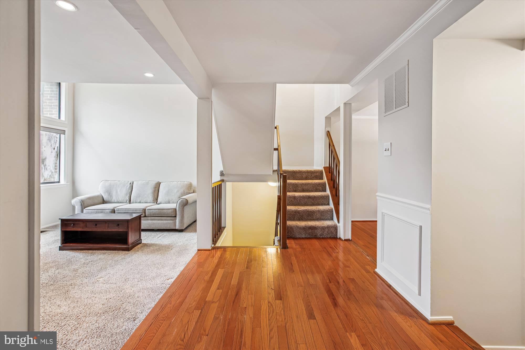 2025 Winged Foot Court Reston, VA 20191 - Photo 9 of 59 a living room with furniture and a wooden floor
