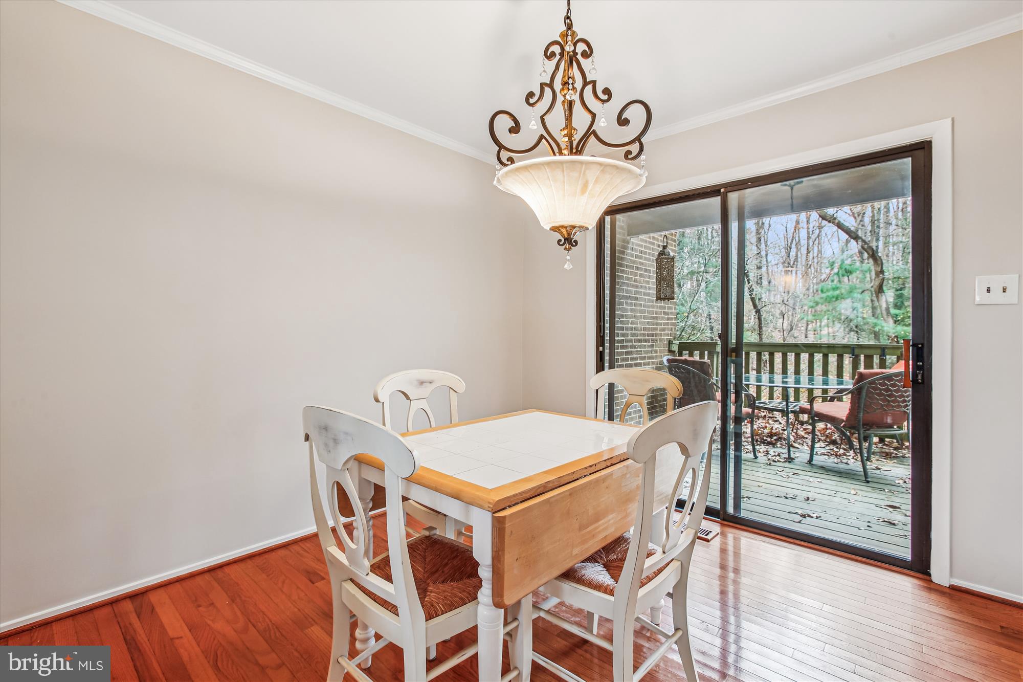 2025 Winged Foot Court Reston, VA 20191 - Photo 10 of 59 a view of a dining room with furniture wooden floor and a chandelier