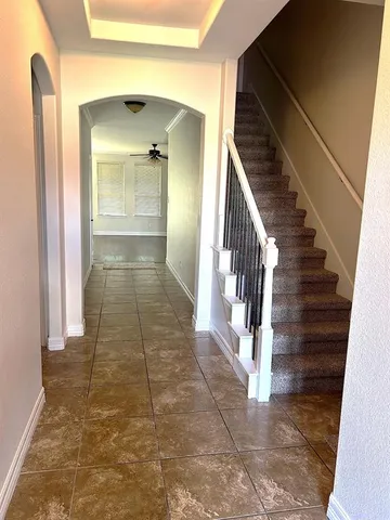 a view of a hallway with wooden floor and entryway