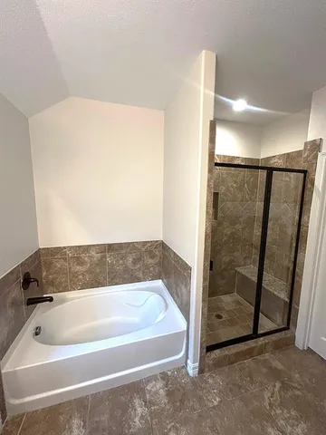 a bathroom with a bathtub and shower