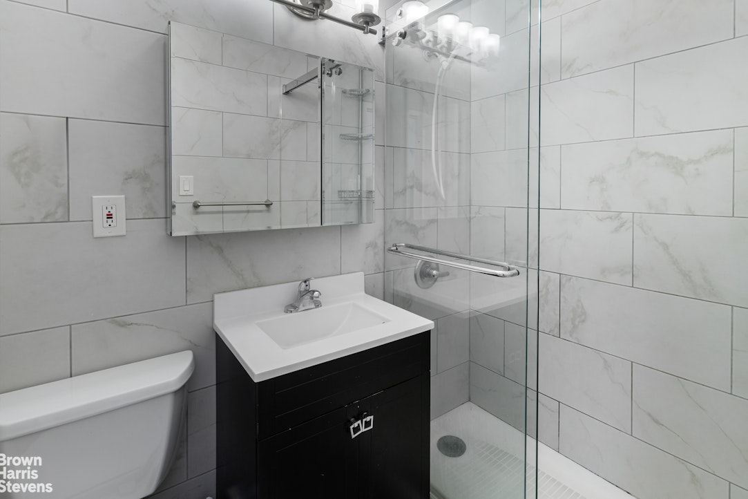 555 Kappock Street, Unit 2E Bronx, NY 10463 - Photo 13 of 39 a bathroom with a sink toilet and vanity