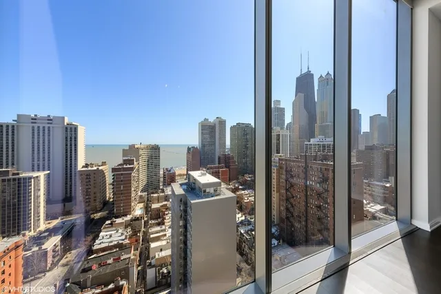 a large white kitchen with granite countertop a large window and a sink