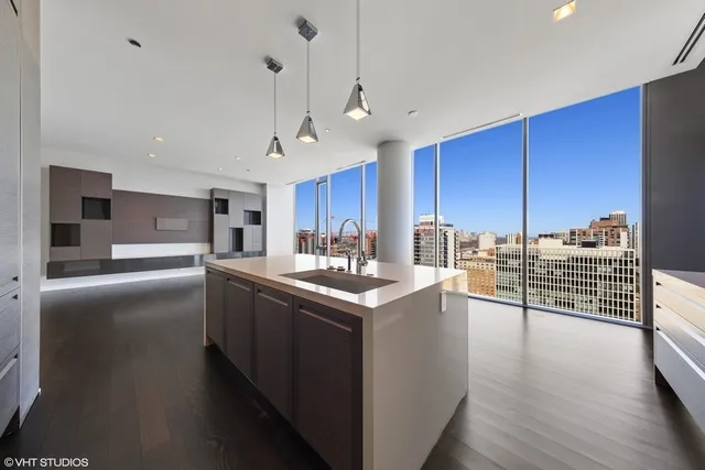 a kitchen with stainless steel appliances granite countertop a sink a stove and a refrigerator