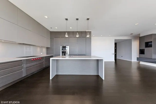 a view with kitchen center island stainless steel appliances wooden floor and living room view