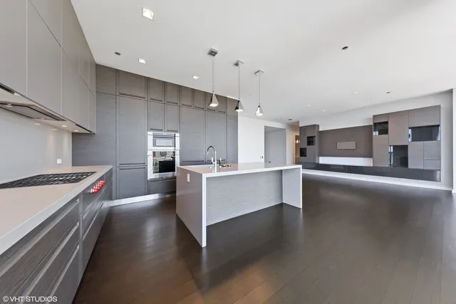 a large kitchen with a large counter top appliances and cabinets