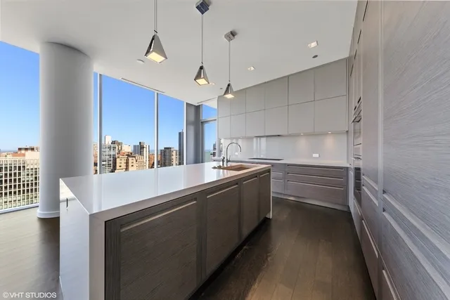 a kitchen that has a sink and cabinets in it